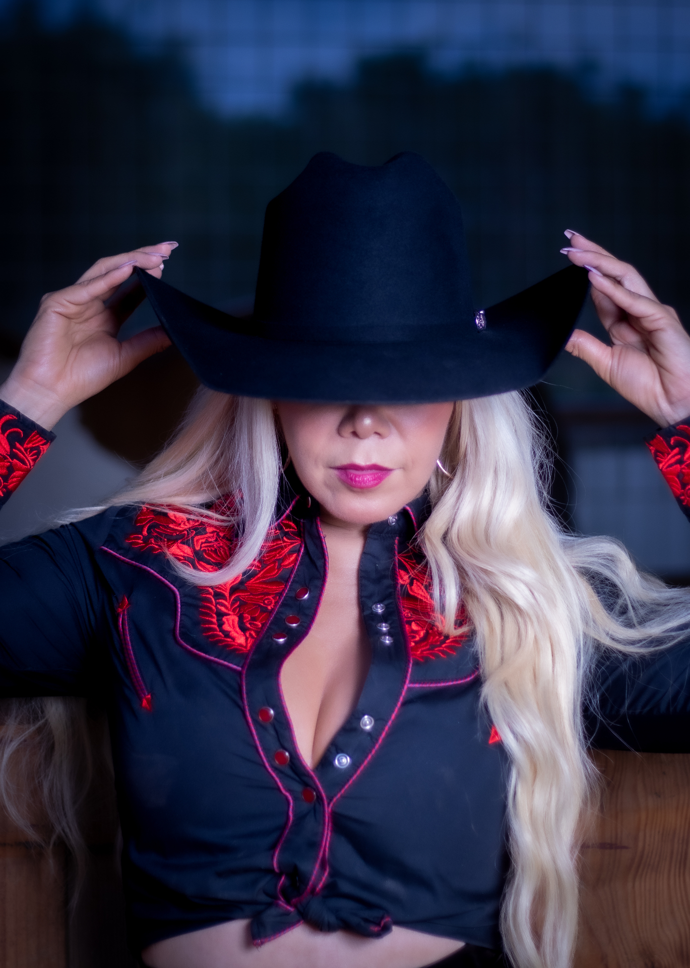 Portrait tipping a black cowboy hat