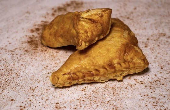 Golden empanadas dusted with cinnamon