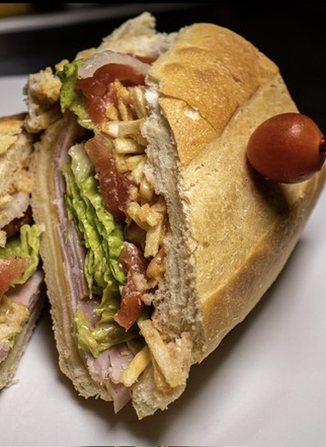 Cuban-style sandwich with lettuce, tomato and ham