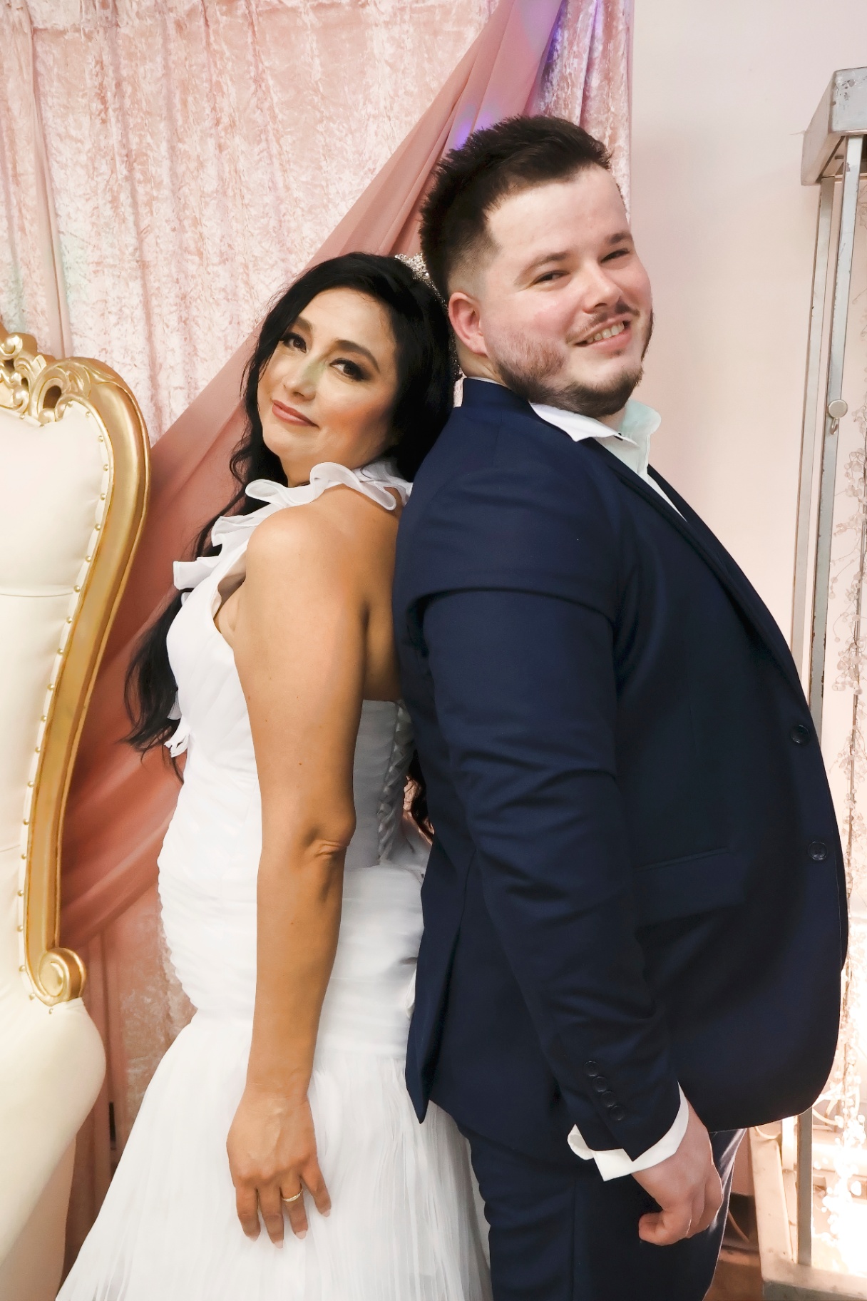 Bride and groom back to back in an editorial pose