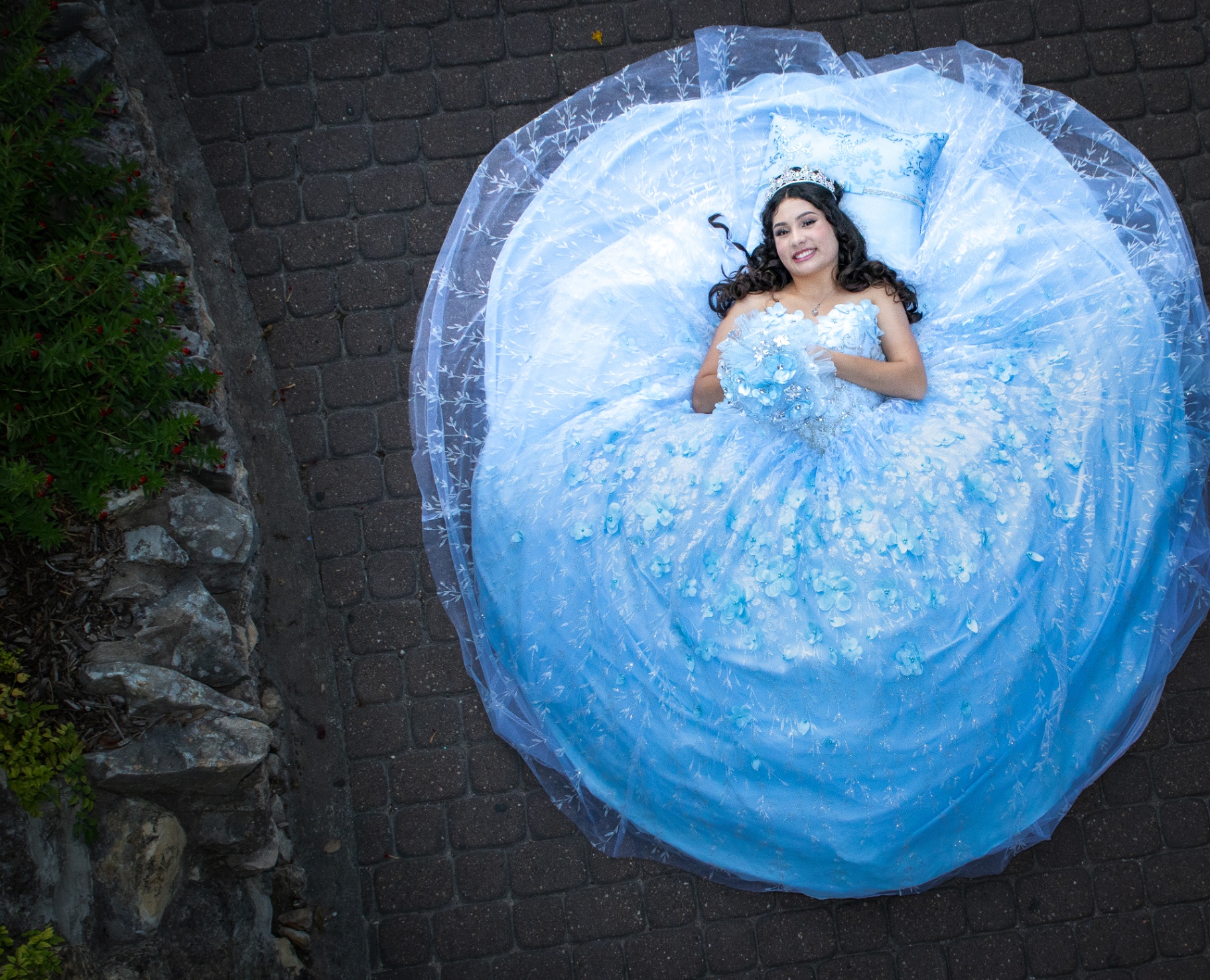 Aerial view of quinceañera in blue floral gown