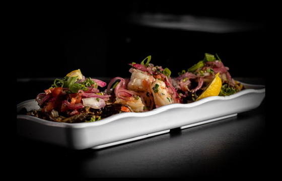 Shrimp ceviche platter with pickled red onion and lemon