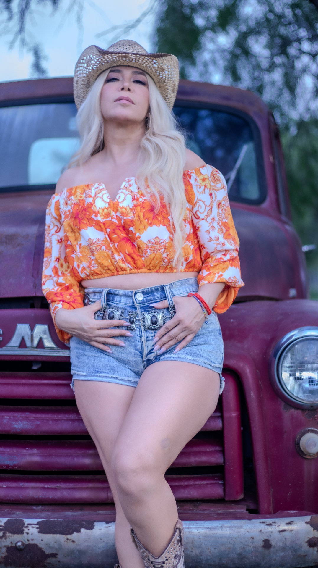 Western editorial portrait against a vintage truck